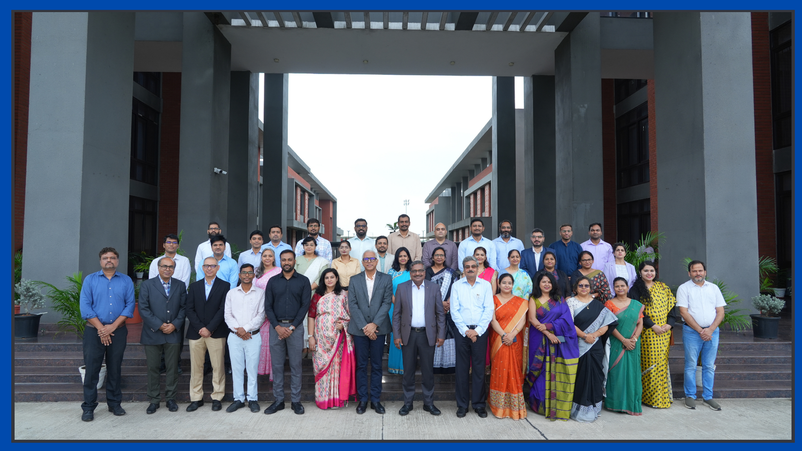 Group photo of the IIM Sambalpur faculty and staff on the steps of the permanent campus