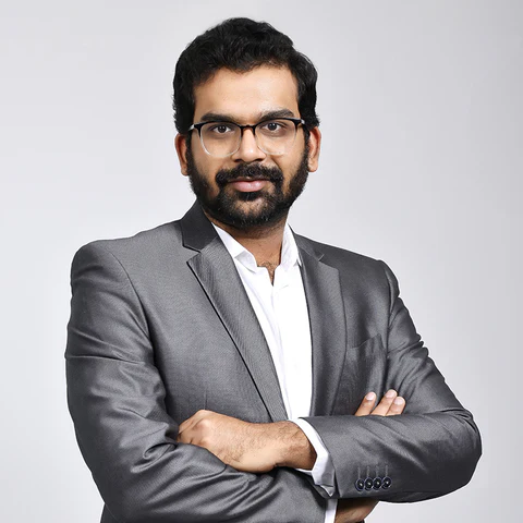 Portrait of Nikita Prasad, Co-founder and Creative Head of GIVA, in a pink blazer against a light backdrop